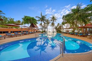 a pool at a resort with chairs and palm trees at Pinnacle Samui Resort in Mae Nam