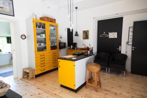 a kitchen with a yellow cabinet and a table at Sdr. Bork in Hemmet