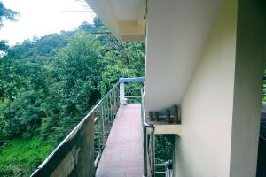 a balcony with a view of a forest at Highland Inn and Restaurant in Banaue