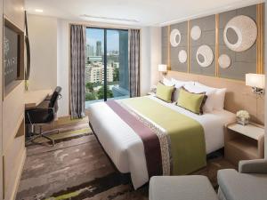 Postel nebo postele na pokoji v ubytování Solitaire Bangkok Sukhumvit 11