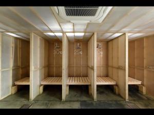 an empty locker room with wooden benches in it at Do-c Shibuya Ebisu in Tokyo