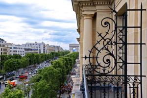 a view of a street from a balcony of a building at Fraser Suites Le Claridge Champs-Elysées in Paris