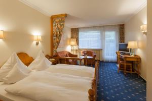 Postel nebo postele na pokoji v ubytování Hotel Garni Fürst von Waldeck