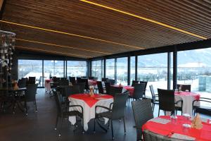 a dining room with red and white tables and chairs at Lazy Bee Camping Village in Aosta
