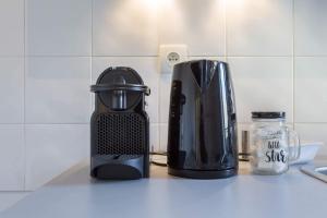 a toaster and a coffee maker on a counter at cocon des artistes in Lyon