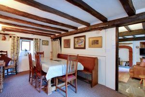 a dining room with a table and chairs at The Low Farm and Duddon View Barn in Broughton in Furness