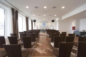 a large room with chairs and a stage in it at Hotel Riviera & Maximilian's in Trieste