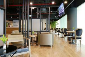 a group of chairs and tables in a room at Sleep Box by Miracle -Booked on Hourly Basis in Bangkok