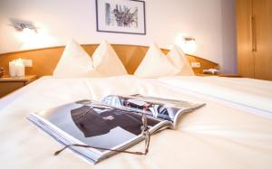 a magazine sitting on the end of a bed at Holzmannhof in Flachau