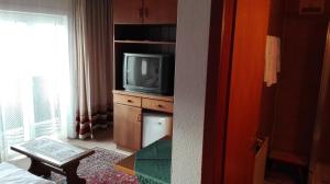 a room with a tv sitting on a dresser at Pension Brunner in Bad Kleinkirchheim