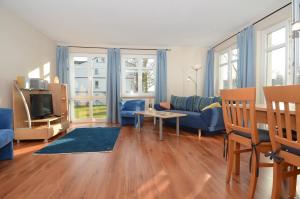 un soggiorno con divano e tavolo di Villa Seerose - Appartement 01 a Ostseebad Sellin