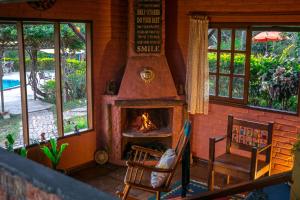 a room with a fireplace in a house at Pousada Villa Lagoa das Cores in Vale do Capao