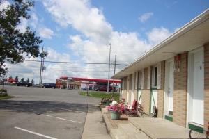 a building in a parking lot next to a gas station at Royal Napanee Inn in Napanee