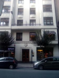 un edificio con dos coches estacionados frente a él en Jan&Joan Apartment, en Bilbao