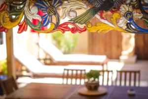 a close up of a chandelier with a table and chairs at VILLA ZENITH Hostel - LA MAISON in Lacanau +26 photos