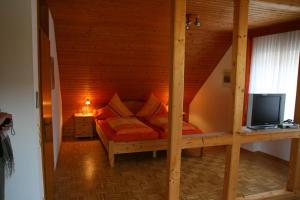 a bedroom with a bed in a wooden room at Weingut & Gästehaus Stephan Kohl in Neumagen-Dhron