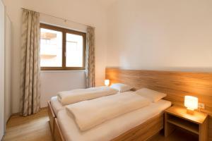 a bedroom with two beds and a window at Verwall Apartment in Schruns-Tschagguns
