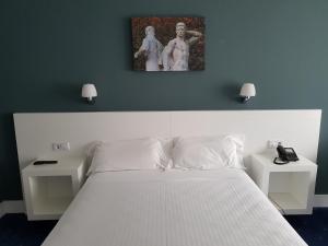 Postel nebo postele na pokoji v ubytování Hotel Gran Regente