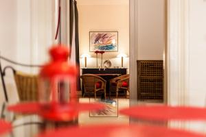 a living room with a table and chairs in a room at Andrassy 91 Apartment in Budapest