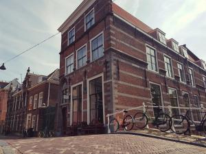 a brick building with bikes parked outside of it at Grand Canal Boutique Hotel Delft in Delft
