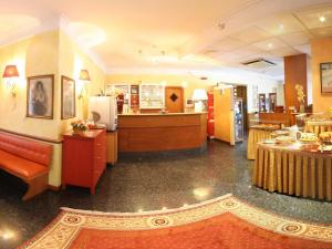 a lobby of a restaurant with tables and a counter at Hotel La Pace - Experience in Cassino