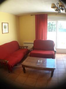 a living room with a couch and a coffee table at Parque Sierra Norte in Rascafría