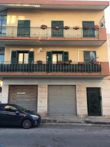 a black car parked in front of a building at Domus Archimede in Siracusa
