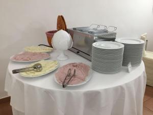 a table topped with plates and bowls of food at Hotel Sant' Antonio in Alberobello