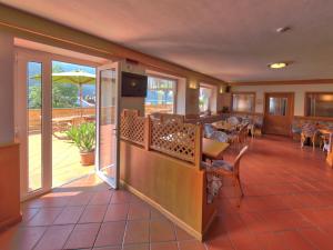 a restaurant with a balcony with a table and chairs at Hotel Garnì Villanova in Molveno