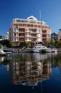 a large apartment building with boats in the water at Mountain Marina Luxury Apartments in Cape Town