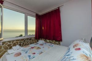 a bedroom with a bed and two windows at Apartments Bluesun in Omiš