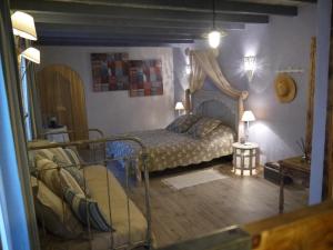 a bedroom with a bed with a canopy at Chambres d'Hôtes Domaine de Beunes in Pailloles