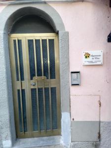 a door to a pink building with a gate at Da Elisa in Riomaggiore
