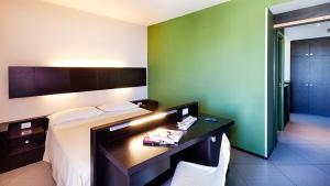 Postel nebo postele na pokoji v ubytování Hotel Lido