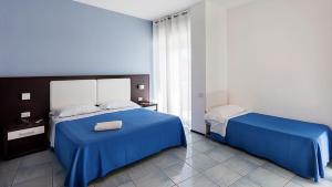 Postel nebo postele na pokoji v ubytování Hotel Lido