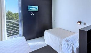 Postel nebo postele na pokoji v ubytování Hotel Lido