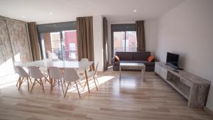 a living room with a white table and chairs at Apartaments Ponent in Lloret de Mar