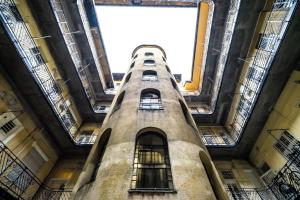 a tall building with windows in the middle at BpR Whistle Arts Industrial Apartment in Budapest
