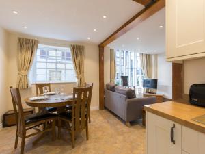 a kitchen and dining room with a table and a couch at Charles I in Winchcombe