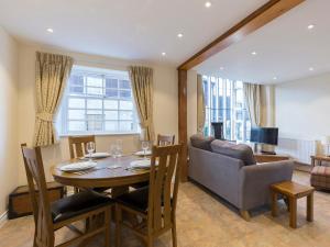 a dining room with a table and a couch at Charles I in Winchcombe +10 photos