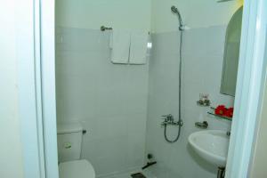 a bathroom with a shower and a toilet and a sink at Truong Ca Hotel in Phan Thiet +22 photos