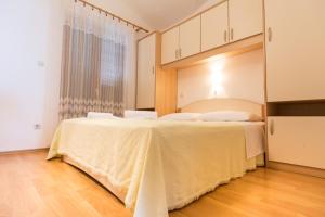 a bedroom with two beds and a window at Apartments Adria in Biograd na Moru +17 photos
