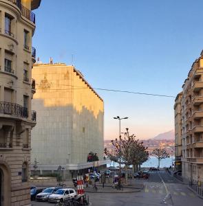uma vista para uma rua da cidade com edifícios e carros em Rue Jean-Antoine Gautier em Genebra