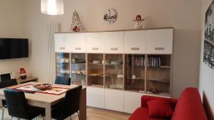 a dining room with white cabinets and a table at Cà di Reno in Casalecchio di Reno