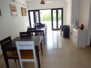 a kitchen and dining room with tables and chairs at Convastay Gajel- Near Apollo Greams Road in Chennai