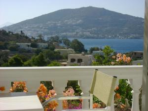 a balcony with a chair and a view of the water at Angelika in Alinda