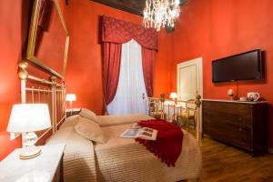 a hotel room with a bed and a television at La Bohème in Lucca