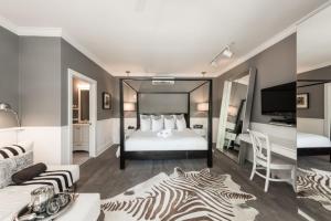 a bedroom with a bed with a zebra print rug at Alexander's Gay Lesbian Guesthouse (Adult Only 21+) in Key West