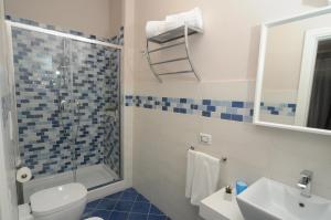 a bathroom with a shower and a toilet and a sink at La Casa di Giorgio Panoramic Rooms in Naples +31 photos