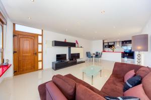 a living room with a brown couch and a table at La Mata Beach Apartment in La Mata